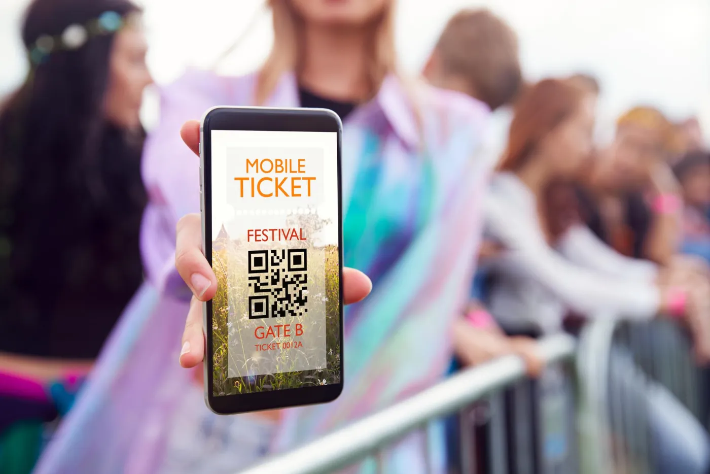 Attendee showing a mobile ticket with a QR code at an event entrance